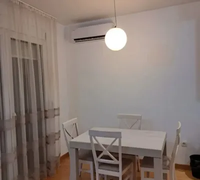 Dining area with a white table and chairs. - image 3
