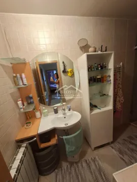 Kupatilo sa umivaonikom, ogledalom i belim elementima za odlaganje. - image 12