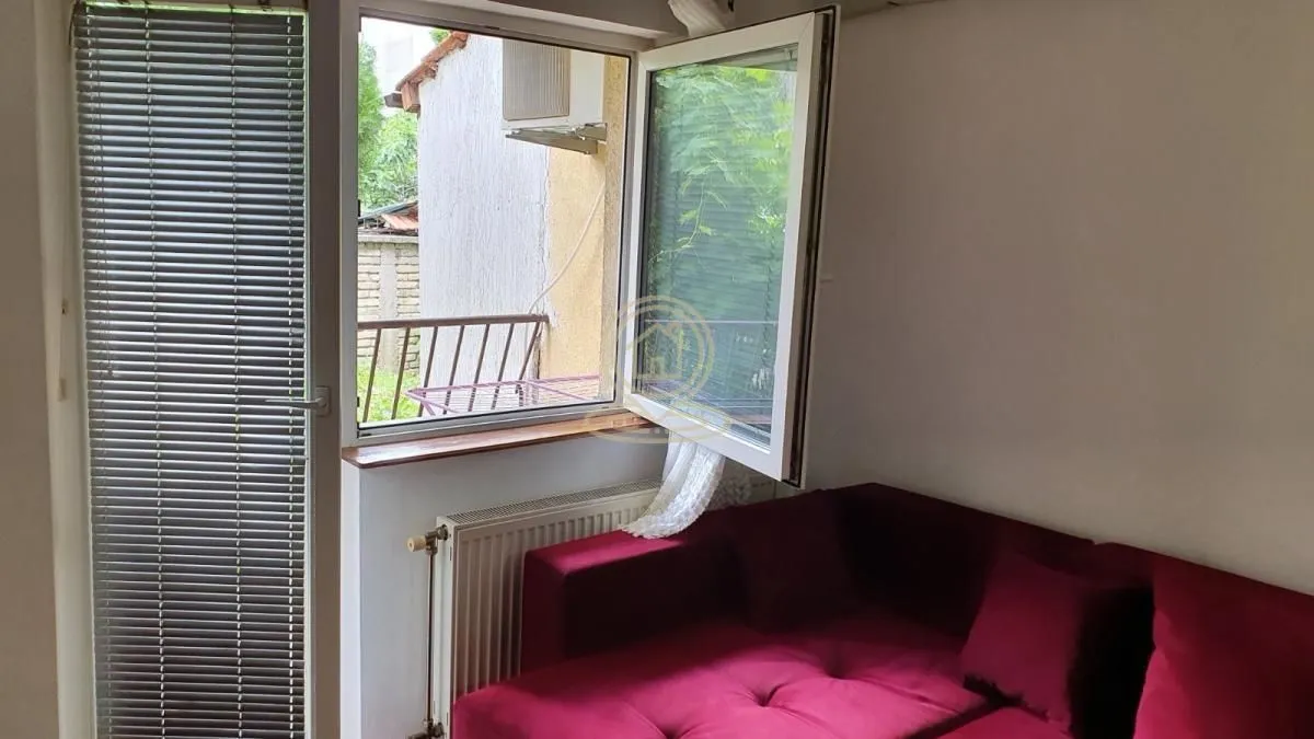 Living room with a sofa and access to the terrace.