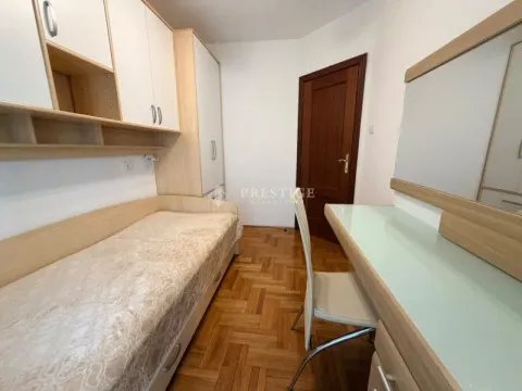 Furnished bedroom with a bed, wardrobe, and desk. - image 8