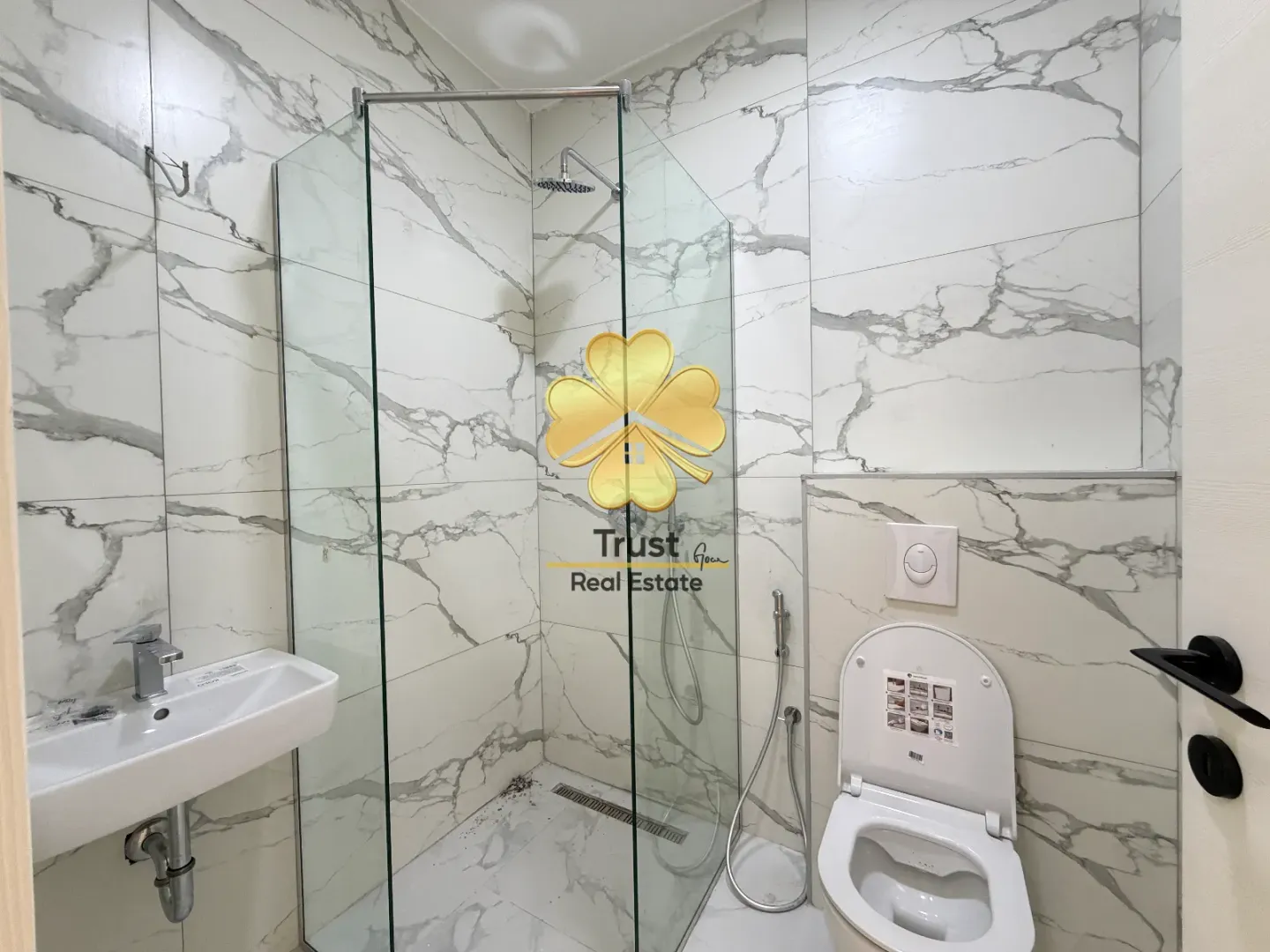 Modernly equipped bathroom with a walk-in shower.