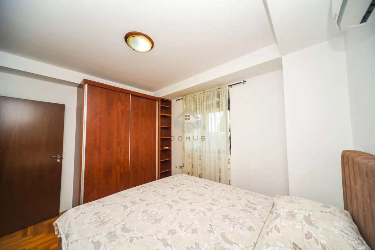 Bedroom with a double bed and a large wooden wardrobe.