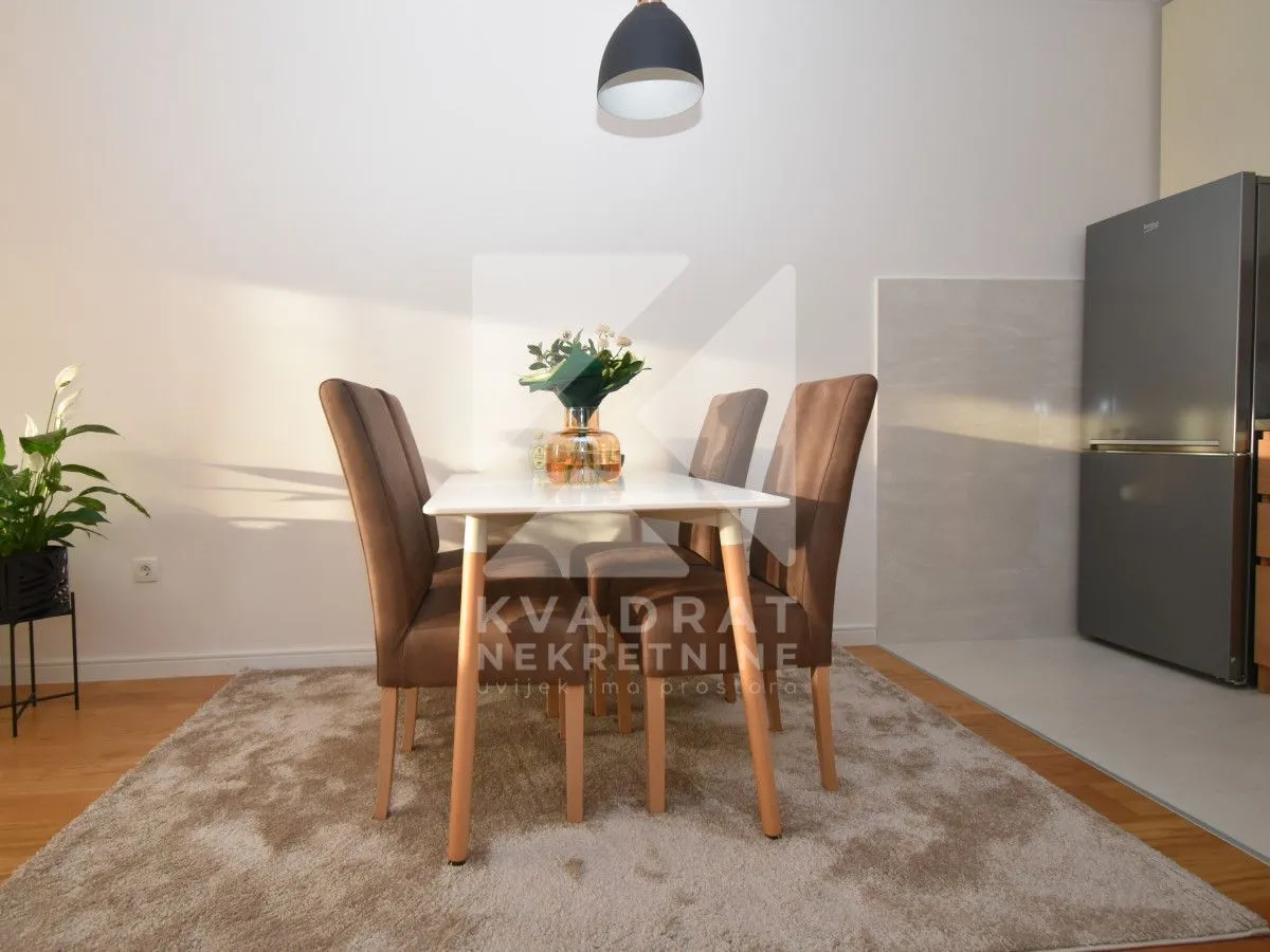 Dining table with chairs as part of the kitchen area.