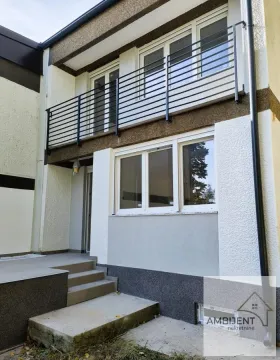 View of the exterior of the building with a balcony and entrance stairs. - image 2