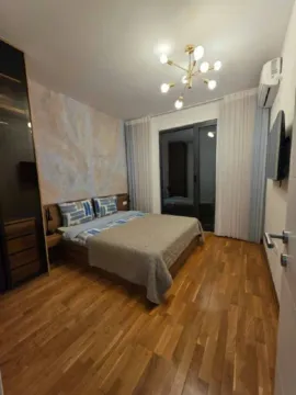 Modern bedroom with a double bed, wooden flooring, and a wardrobe. - image 8