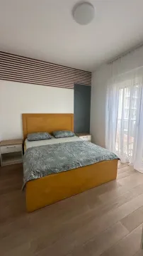 Furnished bedroom with a double bed and a window. - image 6