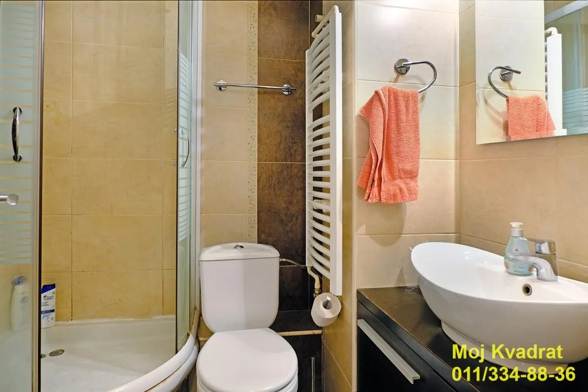 Kupatilo opremljeno tuš kabinom, umivaonikom i WC šoljom.