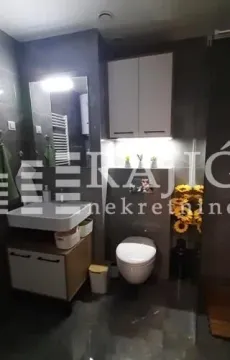 Modern bathroom equipped with a sink and toilet. - image 5
