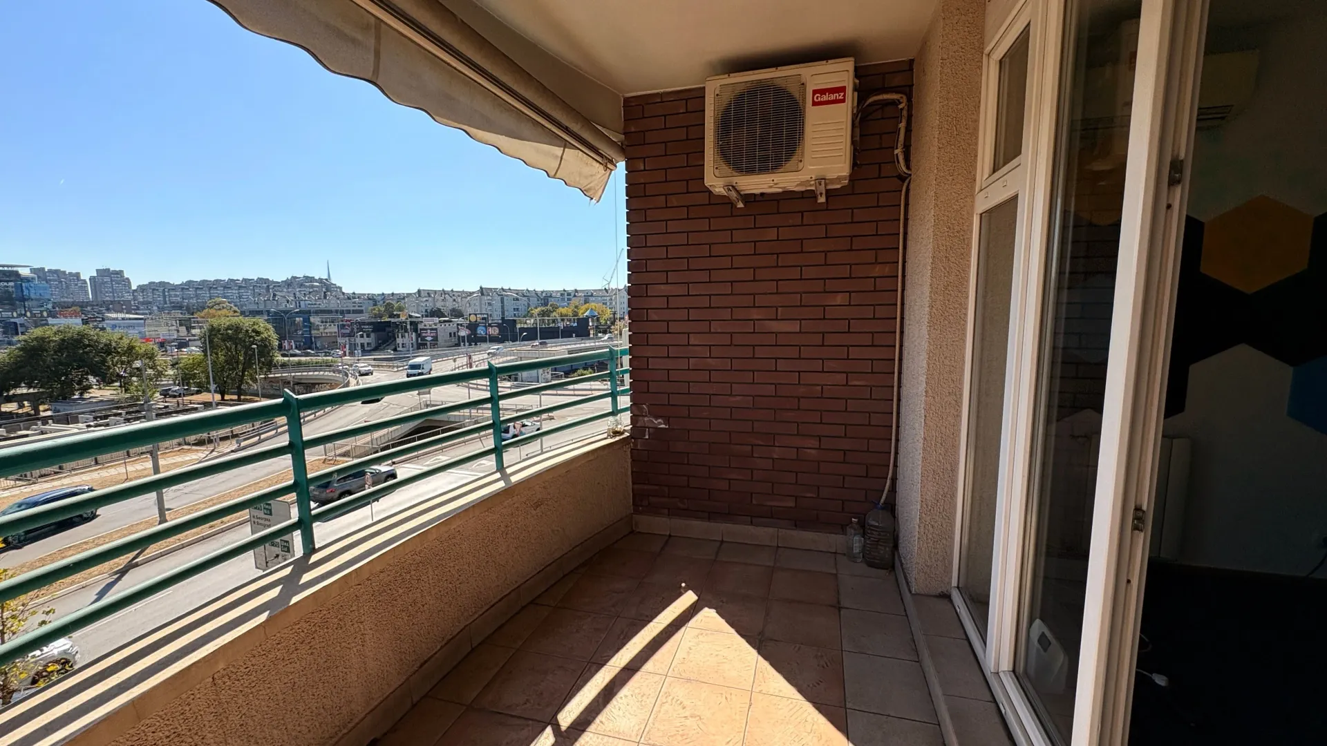 Covered balcony with a view of the city and the road.