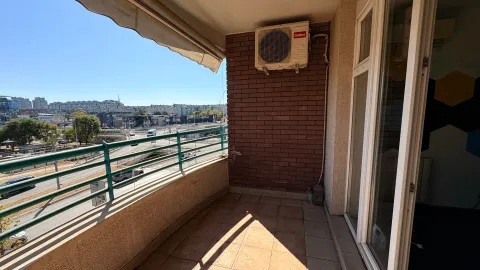 Covered balcony with a view of the city and the road. - image 12