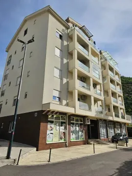 Exterior of a multi-family residential building with balconies and parking. - image 8