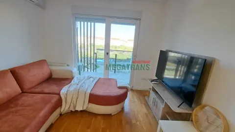 Dnevna soba sa ugaonom garniturom, televizorom i izlazom na balkon. - image 7