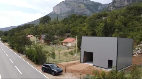 Aerial view of a building next to the road in nature. - image 3