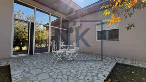 Paved courtyard with seating set in front of the house. - image 19