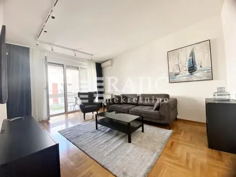 Living room with a sofa, coffee table and access to the terrace. - image 14