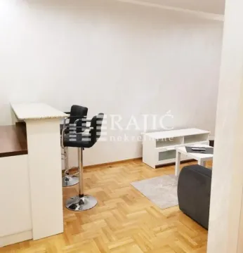 Living room with a dining bar and stools. - image 3
