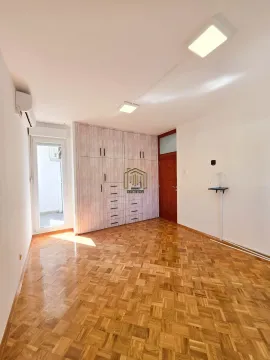 Empty room with a built-in wardrobe and parquet flooring. - image 11