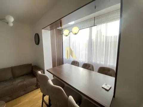 Living room with a dining table and chairs near the window. - image 4