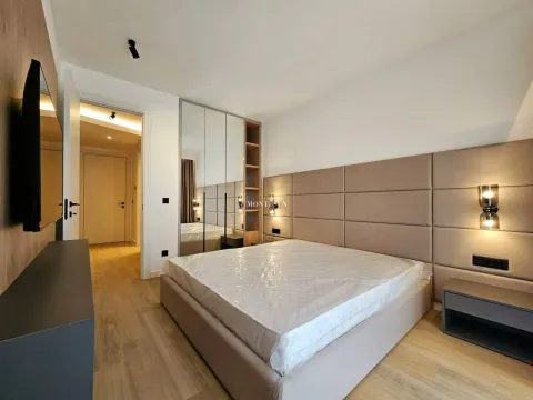 Modern bedroom with a double bed and built-in wardrobes. - image 7