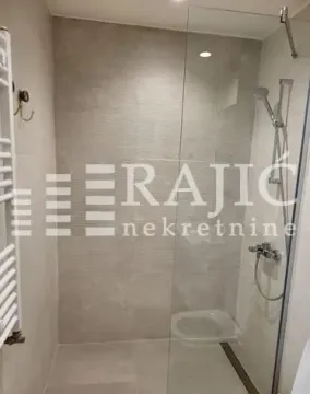 Modern bathroom with a walk-in shower and glass partition. - image 13
