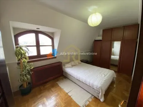 Bedroom with a double bed, wooden wardrobe, and a skylight window. - image 17