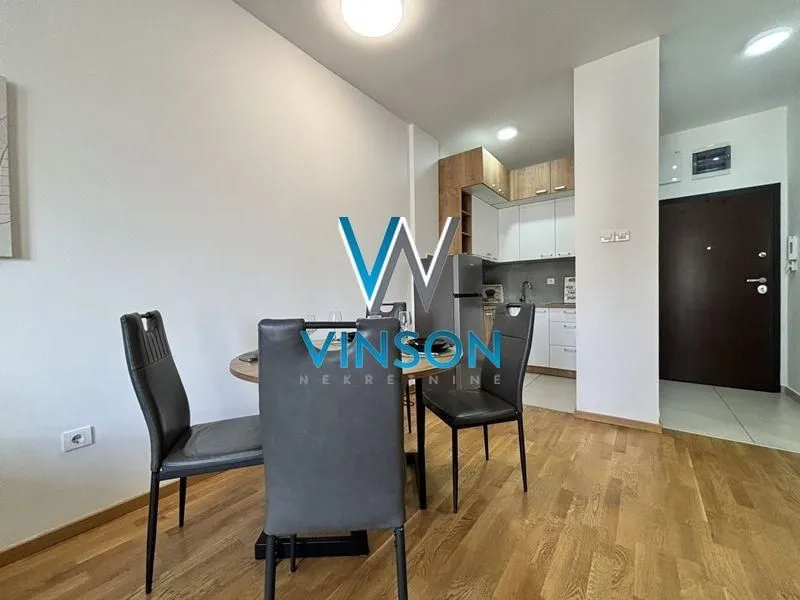 Dining area connected to the kitchen in a bright interior.