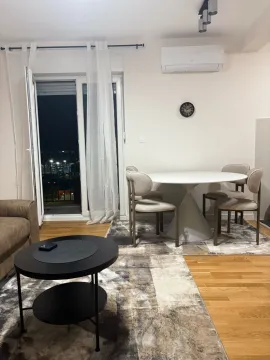 Living room with a dining table and access to the terrace. - image 8