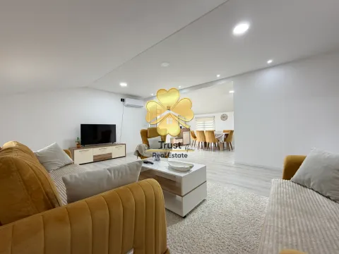 Living room with sofa set, TV, and coffee table. - image 3