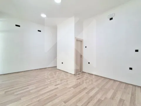 Empty room with white walls and wooden flooring. - image 6