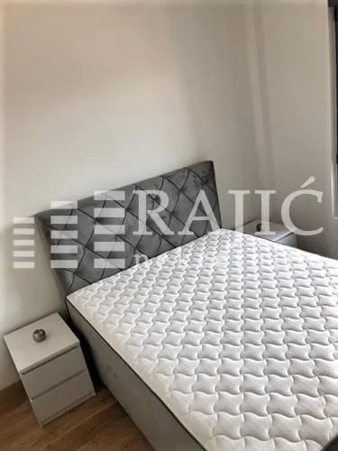 Bedroom with a double bed and a nightstand.