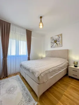 A decorated bedroom with a double bed, window, and curtains. - image 5
