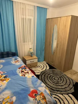 Furnished bedroom with a bed, wardrobe, and nightstand. - image 7