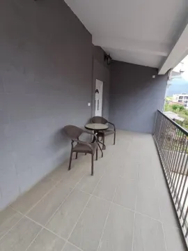 Spacious covered terrace with a table and chairs. - image 2