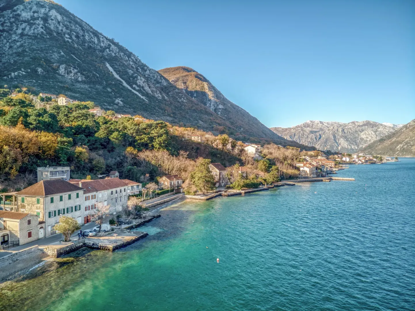 View of the coastline and surrounding mountains from the sea.