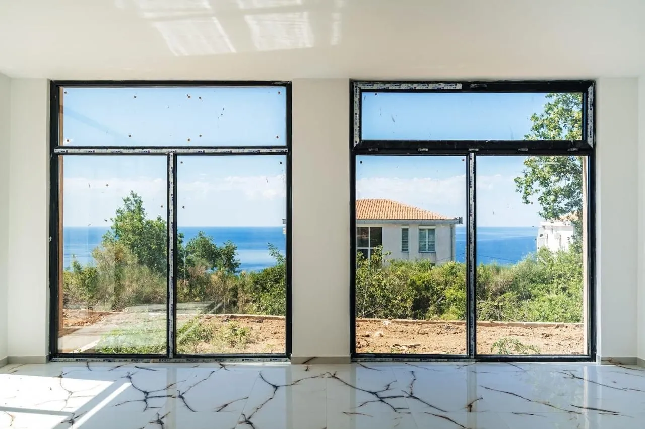 Bright room with large windows and a sea view.