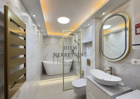 Modernly equipped bathroom with a bathtub, shower cabin, and white marble tiles. - image 8