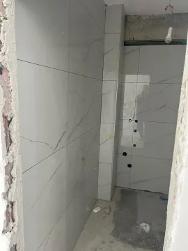 Bathroom under renovation with installed ceramic tiles. - image 7