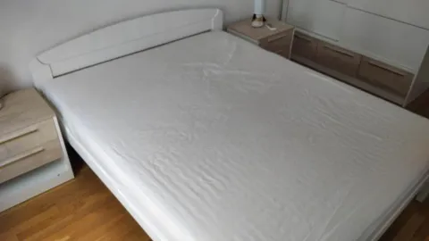 Bedroom with a double bed and nightstands. - image 16
