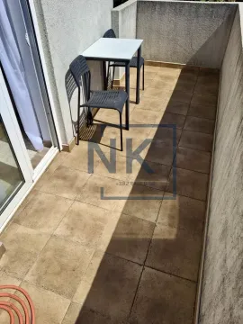 Narrow tiled terrace with a small table and two chairs. - image 8