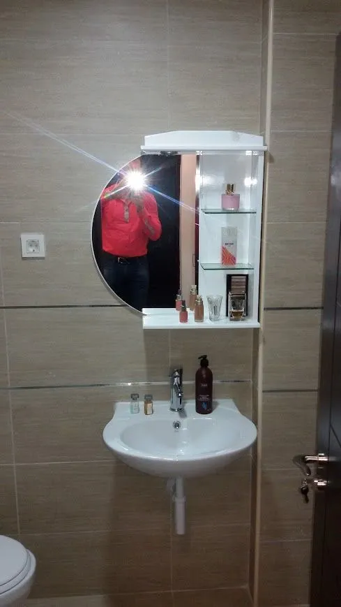 Smaller bathroom with a sink and a mirror.