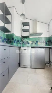 Small kitchen with grey cabinets and green ceramic tiles. - image 5