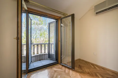 Bright empty room with parquet flooring and open balcony doors. - image 8