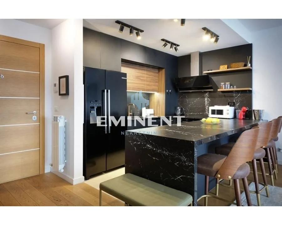 Modern kitchen with a breakfast bar and black elements in the interior.