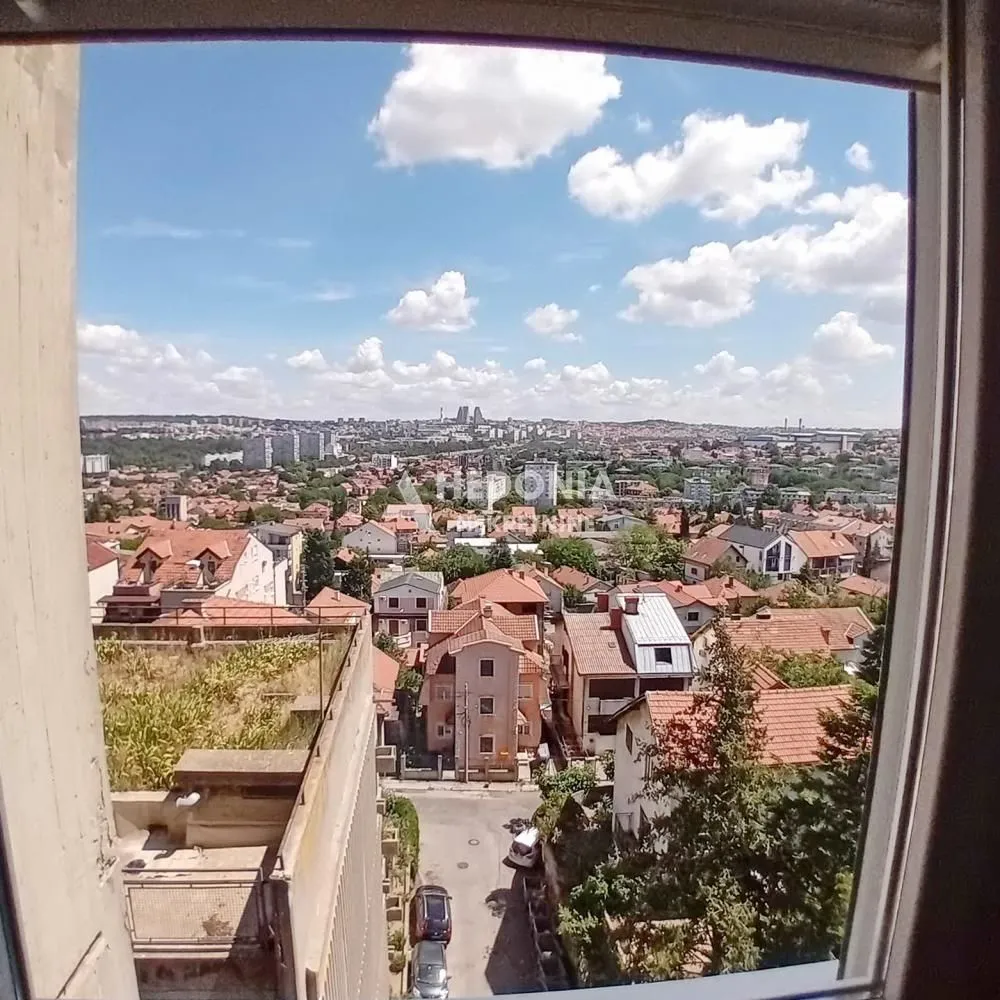 View from the window of the cityscape and surrounding buildings.