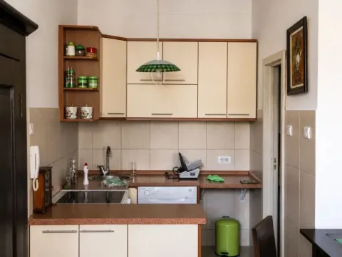 Small kitchen with light-colored cabinets and a sink. - image 11