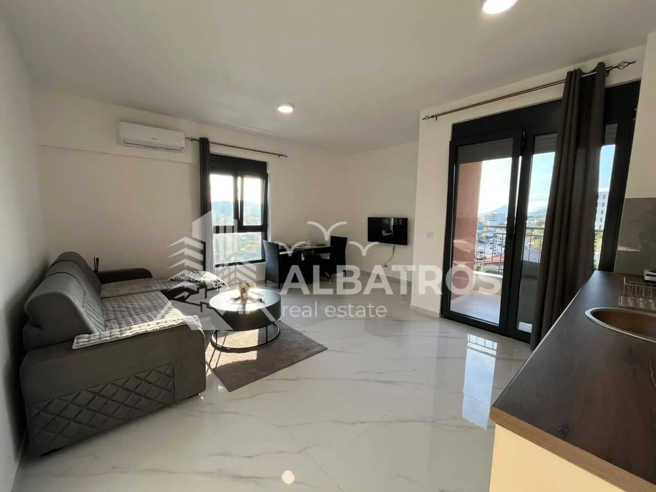 Living room with a sofa and access to the terrace.