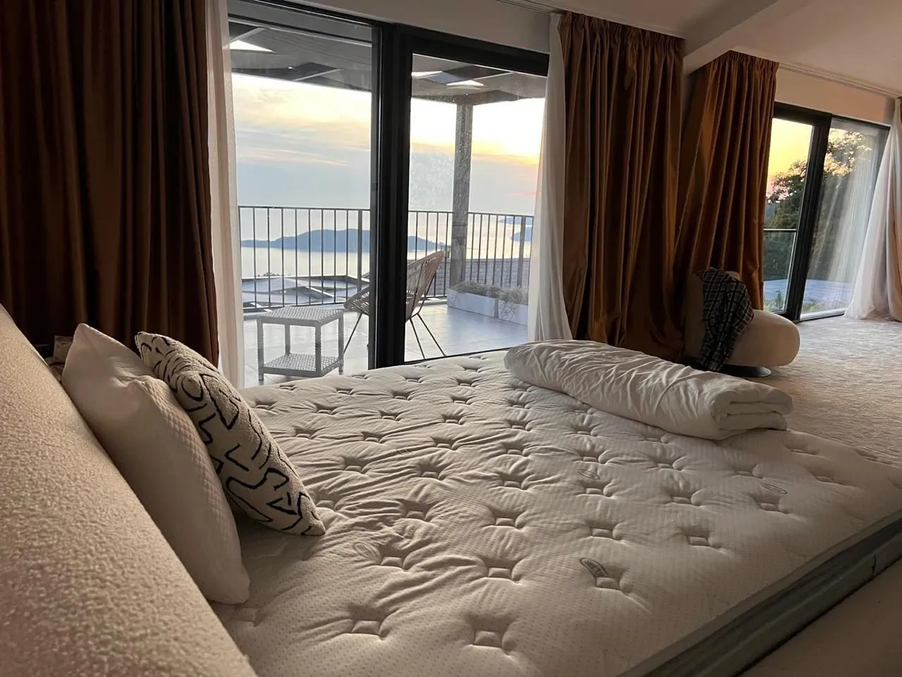 Spacious bedroom with a large double bed and a sea view.
