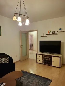 Living room with furniture, television, and a view of the hallway. - image 8