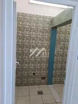 A view of part of a tiled bathroom with wall tiles and a floor drain. - image 3