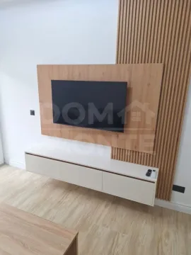 Living room with a TV and modern wooden wall panels. - image 7